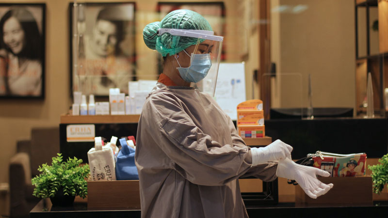 doctor putting on rubber gloves